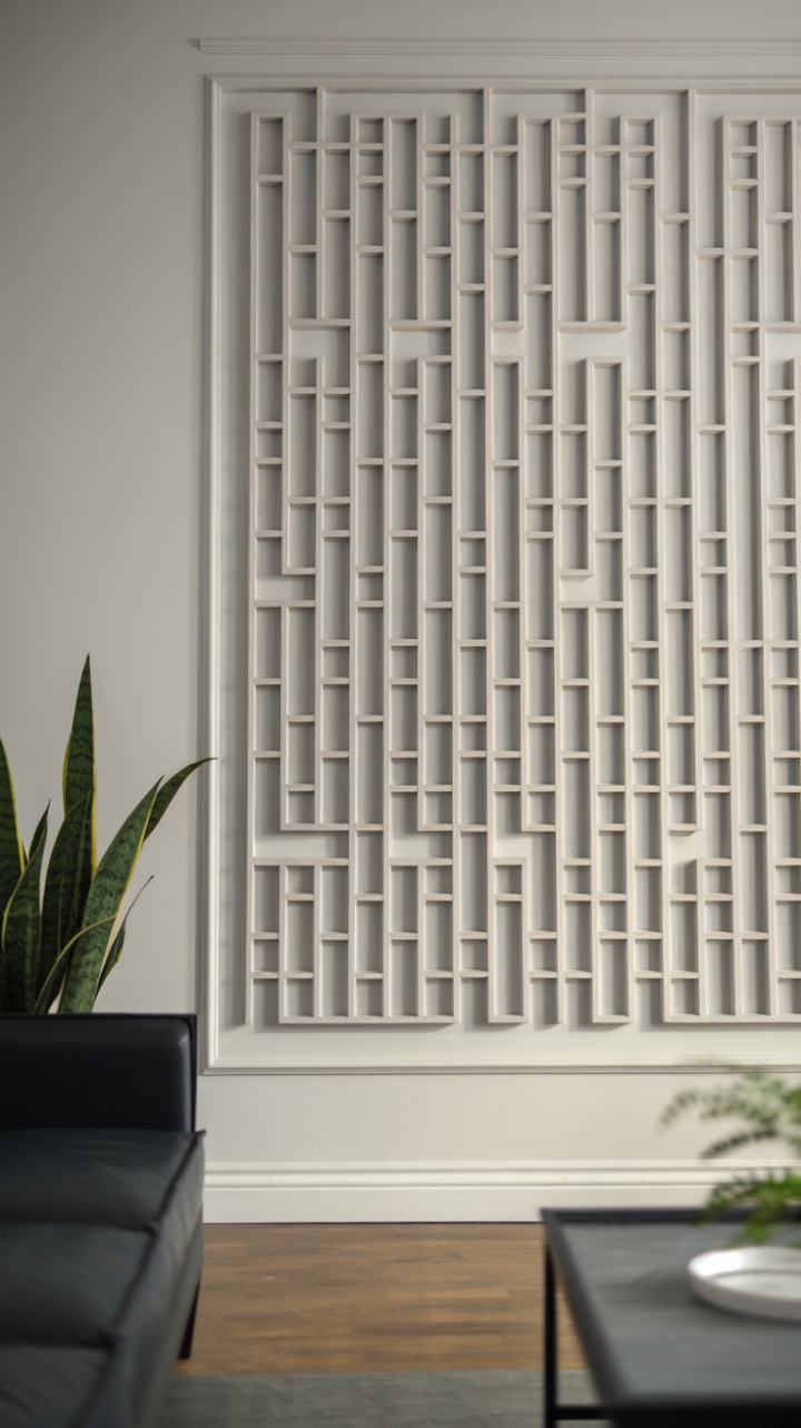 This stunning contemporary wall paneling showcases a striking geometric pattern that adds depth and sophistication to the minimalist room. Crafted from wood and painted in a crisp white, the paneling serves as a stunning backdrop for the sleek sofa and elegant coffee table, creating a harmonious balance of texture and simplicity. A potted plant introduces a touch of nature, while the warm wooden floor and soft lighting envelop the space in a serene ambiance, making it the perfect retreat for relaxation and style.