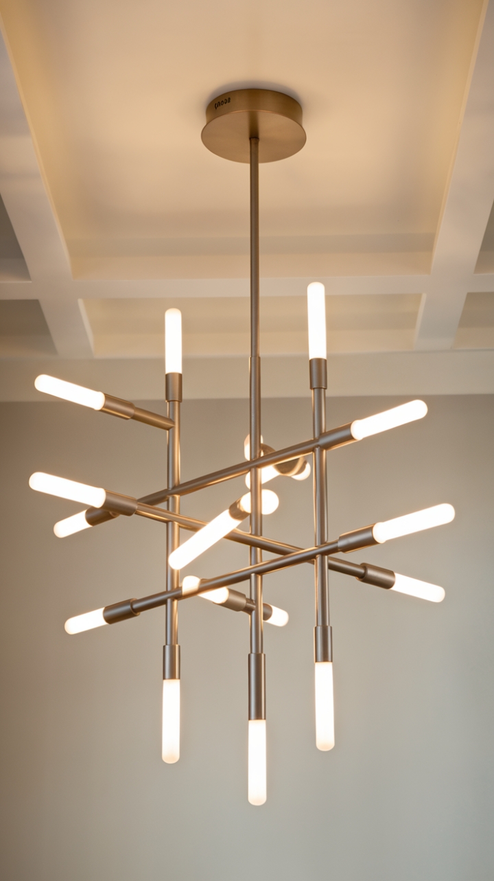 Sculptural simplicity meets incandescent brilliance. This contemporary chandelier's minimalist design is a masterclass in understated elegance, its sleek lines and multiple pendant lights casting a captivating glow.